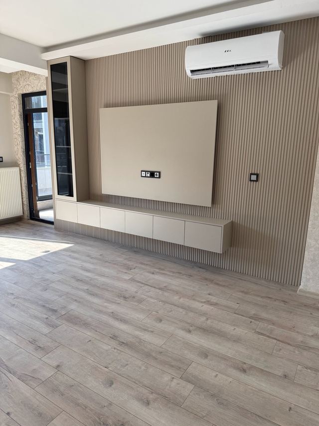 Wohnzimmer mit TV-Wand und Klimaanlage